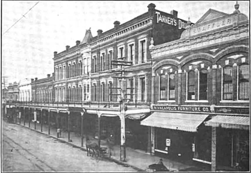 Black-and-white view of Pacific Avenue in Santa Cruz in 1903, lined with ornate commercial buildings.